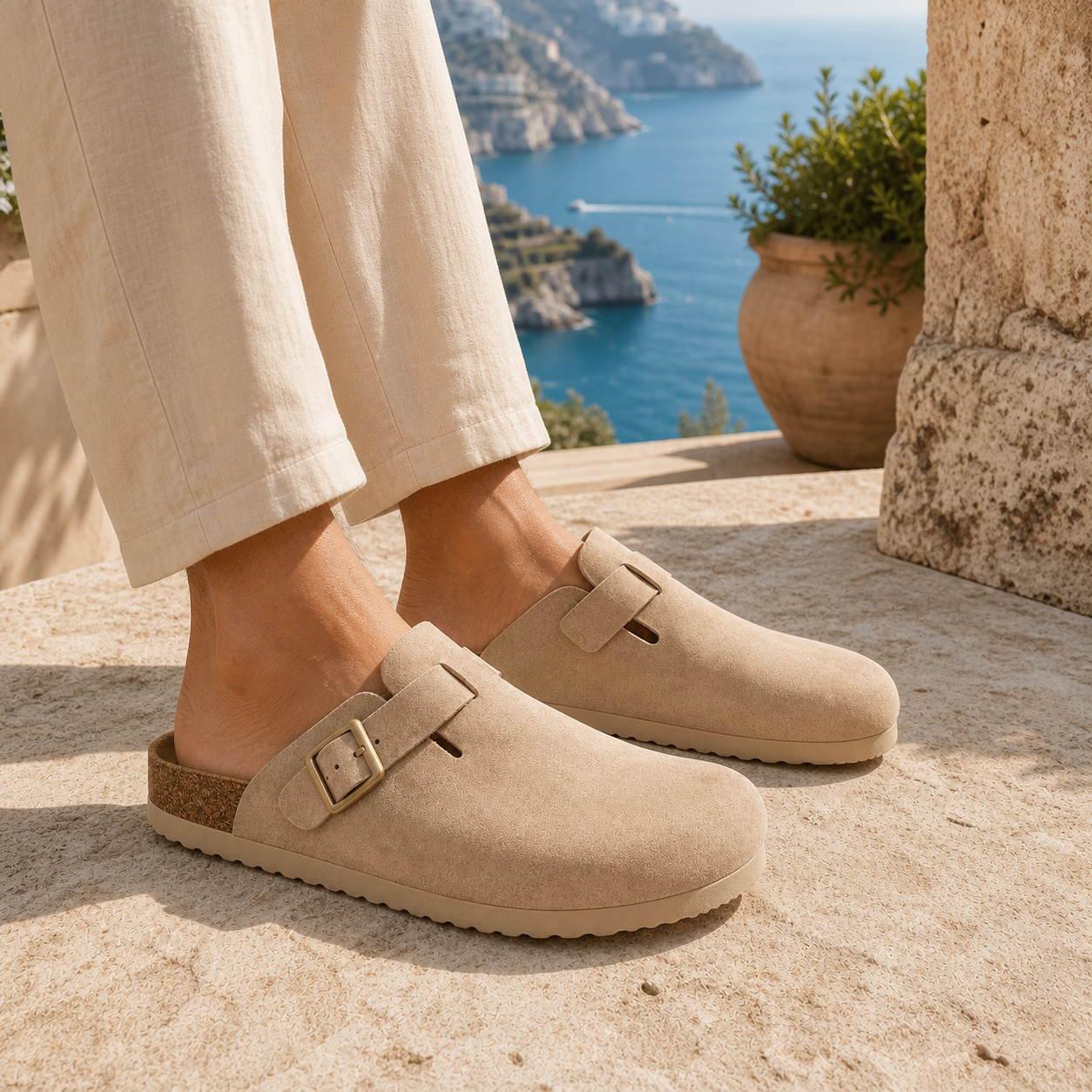 Model wearing Monte Aure Sorrento Sand Clog sandals by the sea
